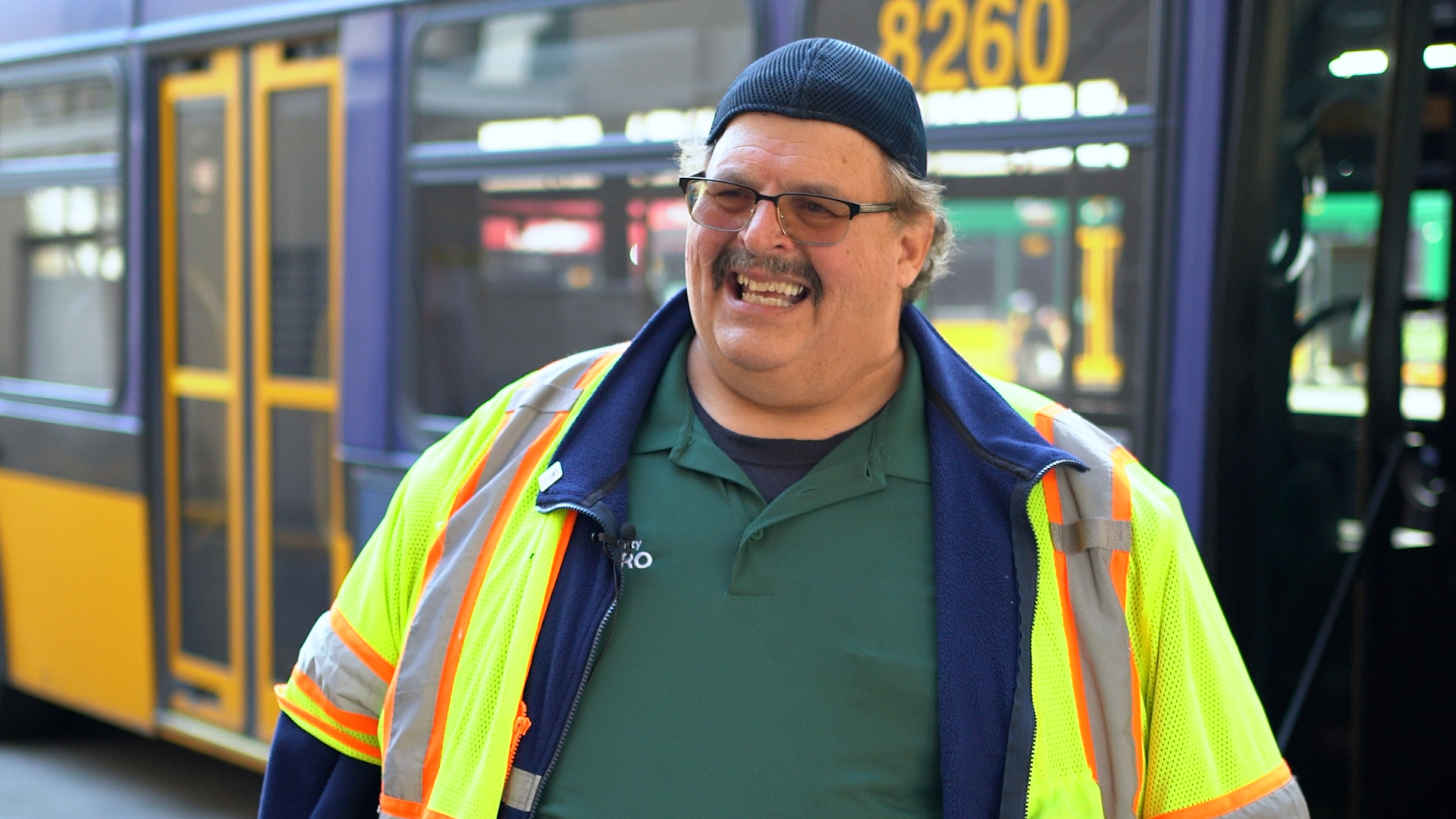 Picture of Jack Millman, Metro's Operator of the Year, in front of a metro bus. 