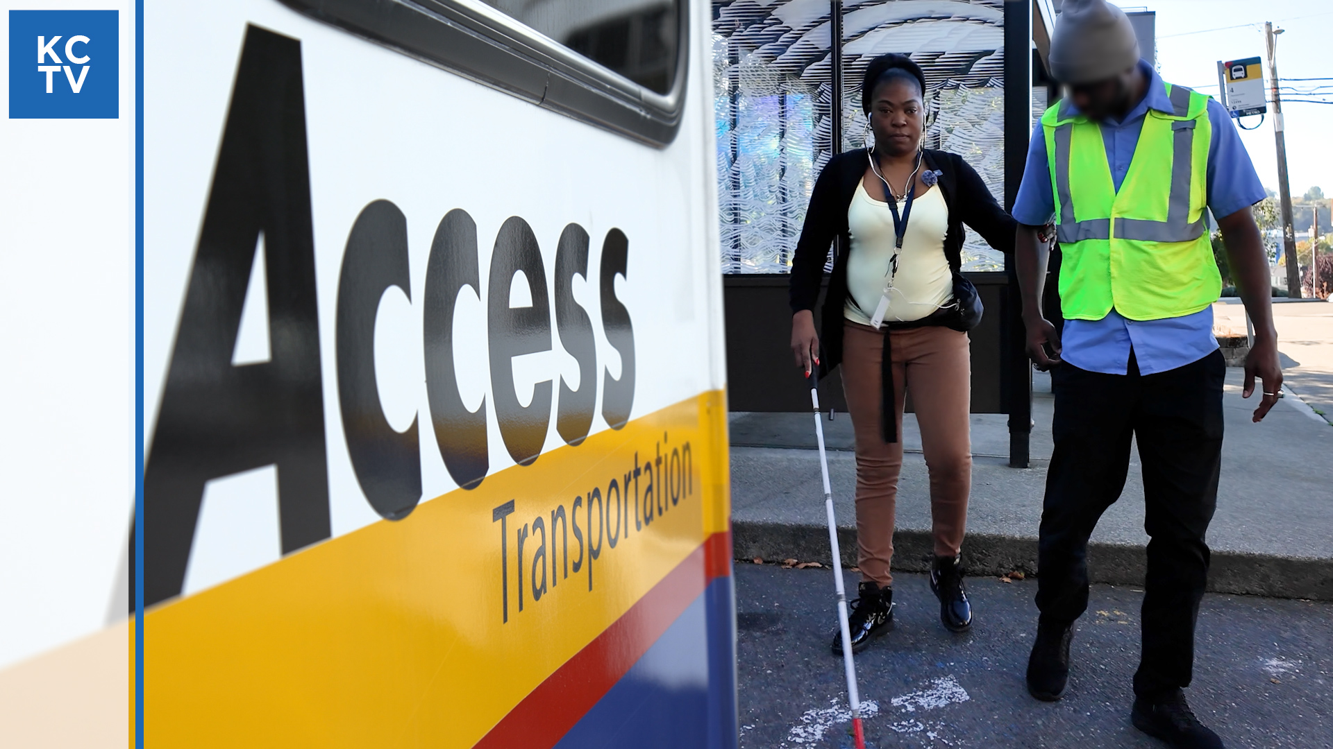 photo of the side of a van with the words Access Transportation beside a blind rider being led by the driver